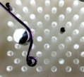 Instructions for making Beaded Chandelier Earrings Step 4 showing jewelry wire being shaped on WigJig jewelry tool.