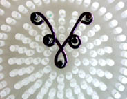 Instructions for making Wire Chandelier Earrings showing shaping jewelry wire on WigJig jewelry making tool .